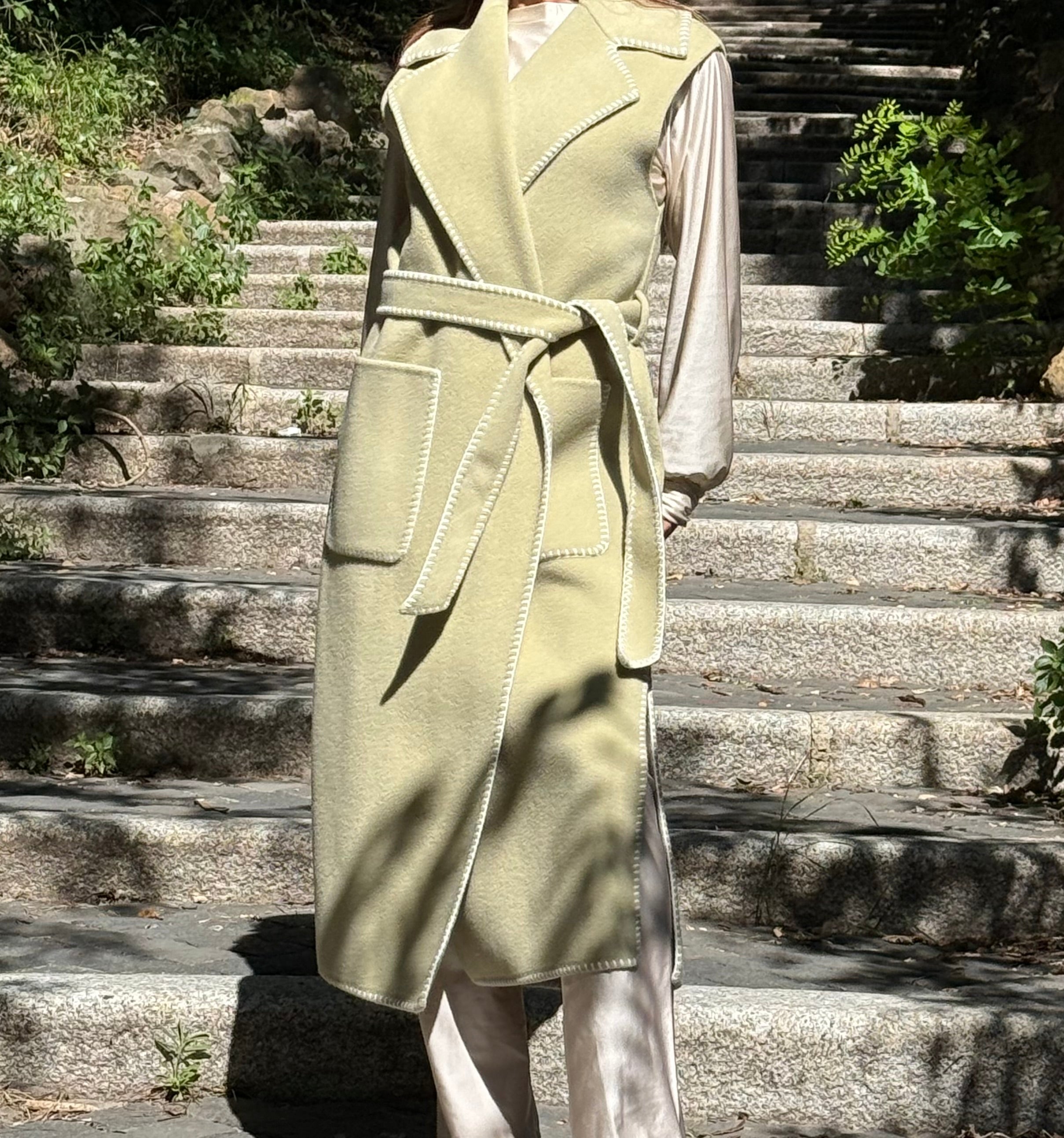 Tailored sleeveless light green wool coat limited edition